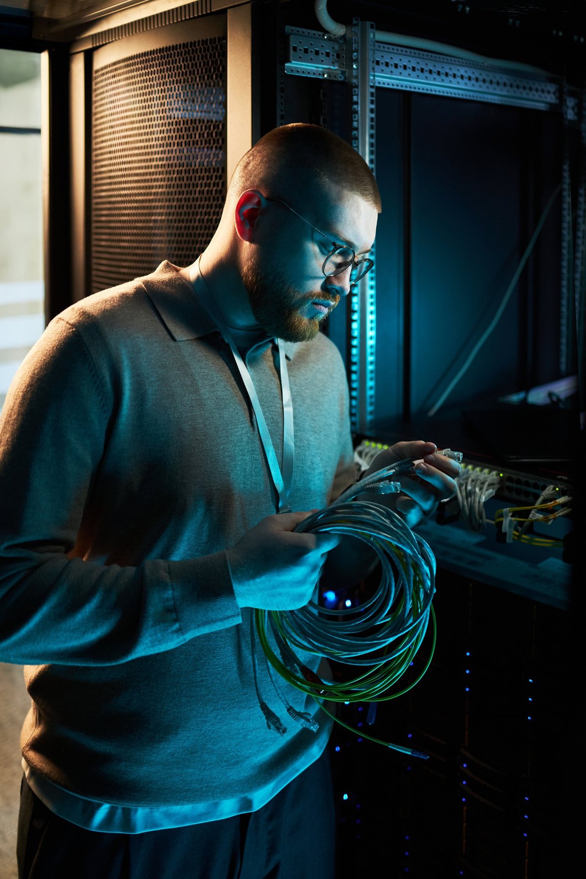 Technician managing server cables in a data center